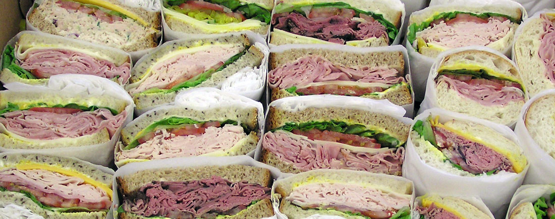 Tray of wrapped sandwiches for a holiday office lunch